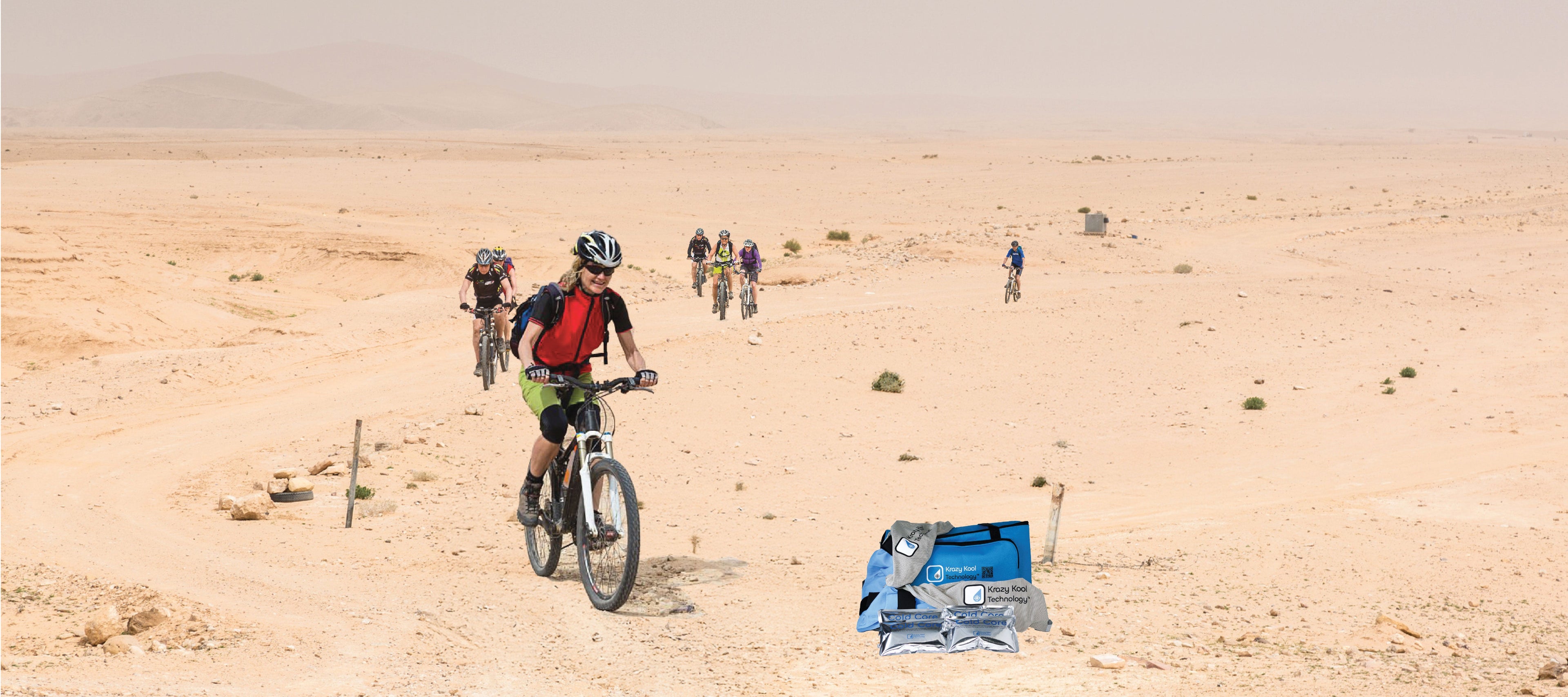 Bikers riding through a desert landscape with a Krazy Kool Technology System featured in the front on the ground.
