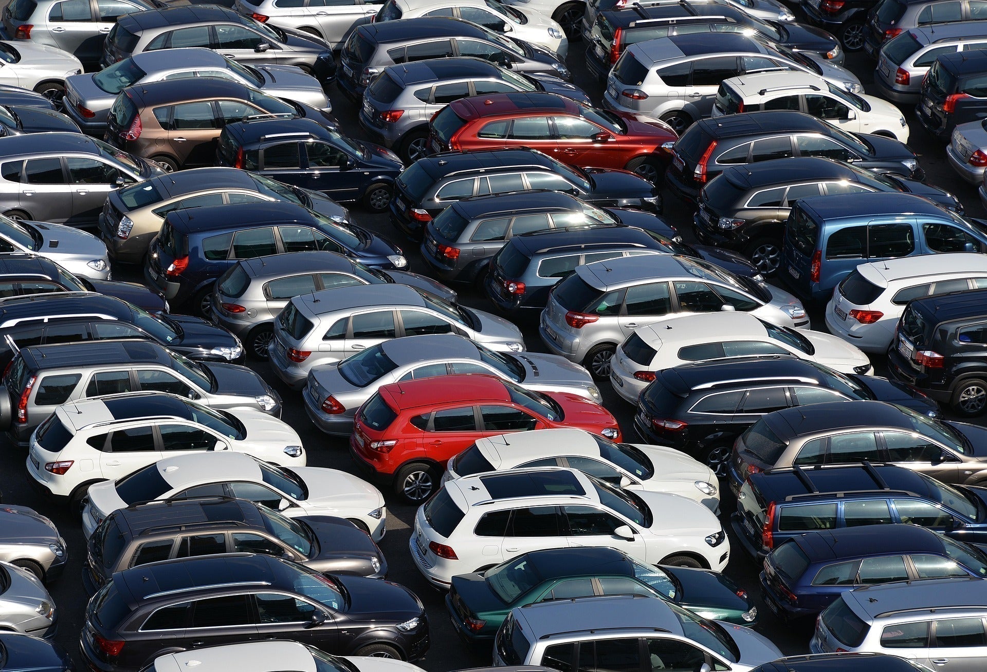 Sea of parked cars in direct hot sun on summer's day