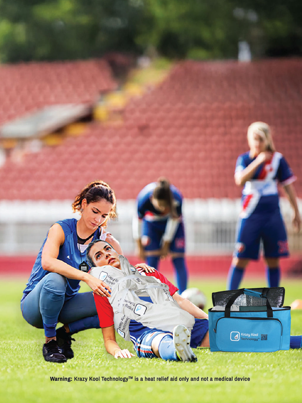 Professional female soccer team exhausted after a long outdoor practice with one woman feeling faint and needing medical assistance showcasing the use of the Thermal Storage Bag and full Krazy Kool Technology cold therapy Protection System on her core body heat zones.