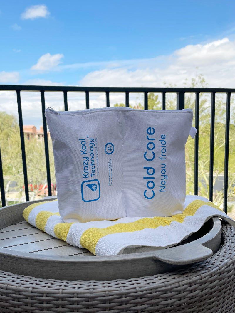 Cold therapy ice packs in thermal storage pouch sitting on beach towel with balcony view in sunny California