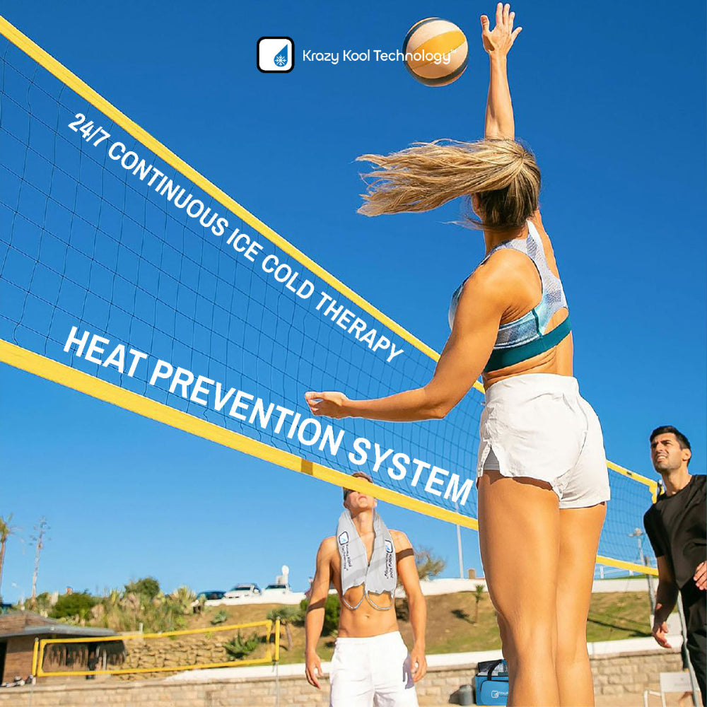 Female volleyball player spiking the ball to male athlete wearing Krazy Kool Tech System on beach on sunny summer day with Thermal Storage bag